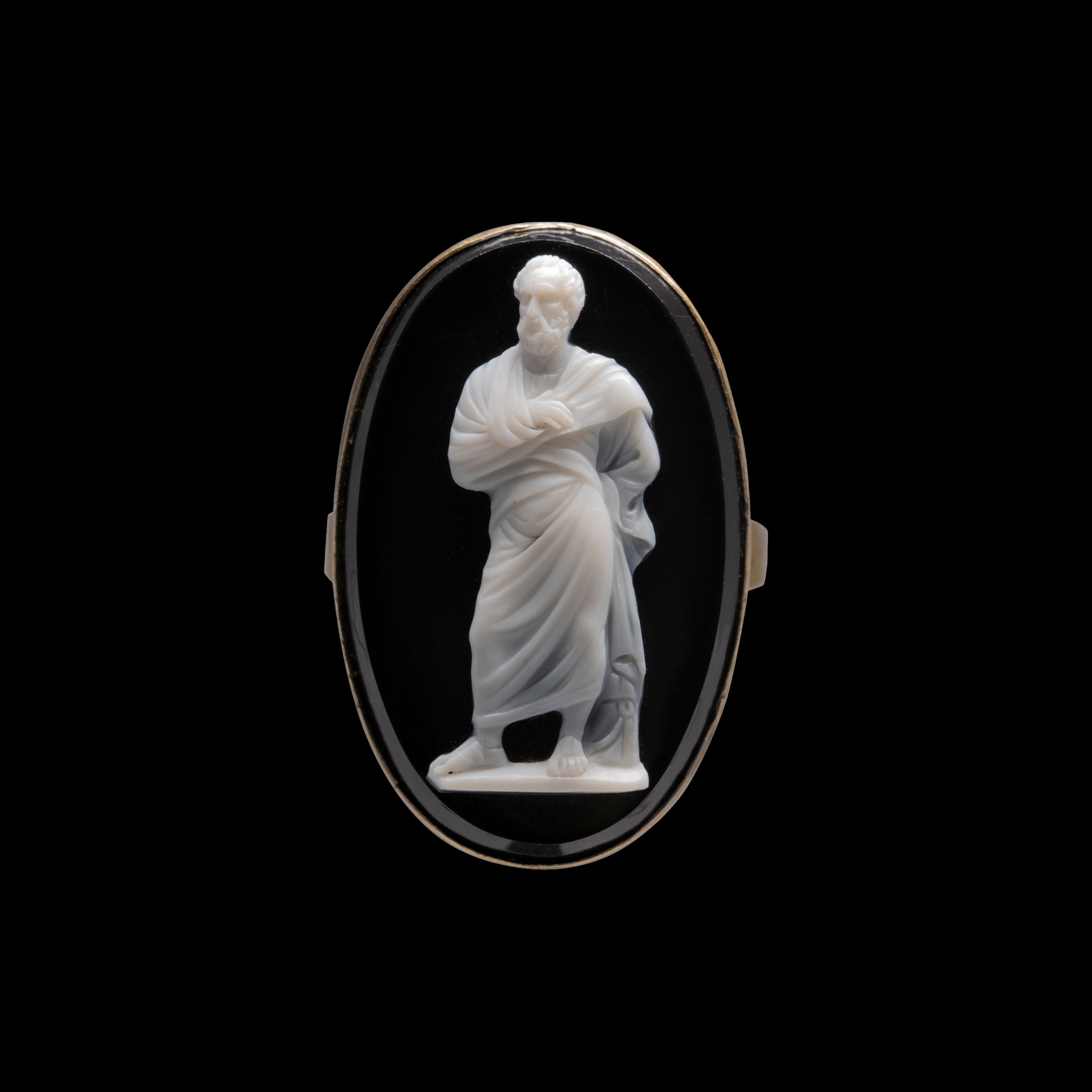 A Neoclassical onyx cameo set in a gold ring. Demosthenes. 